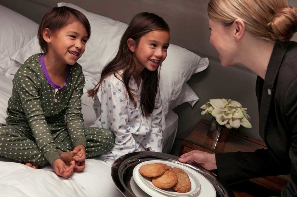 Butler Serving Cookies to Children